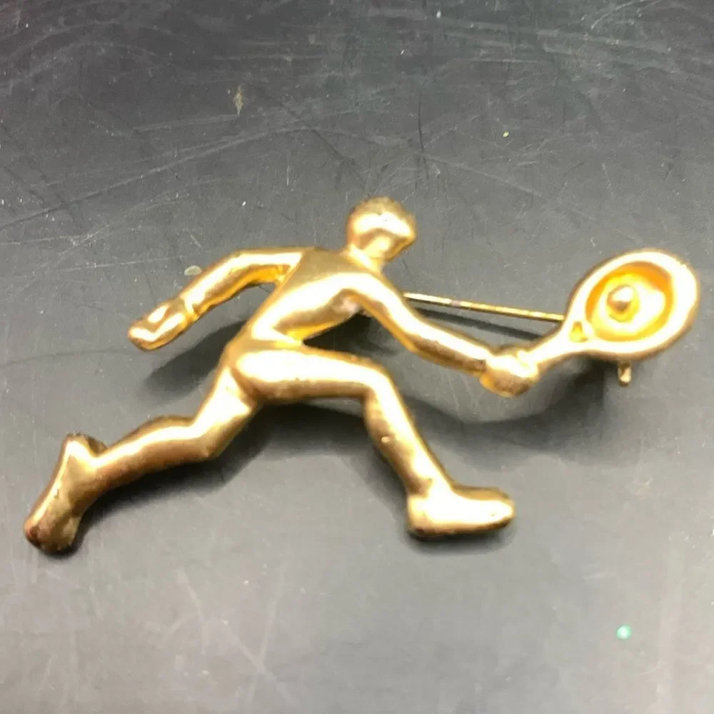 Gold tennis player pin brooch